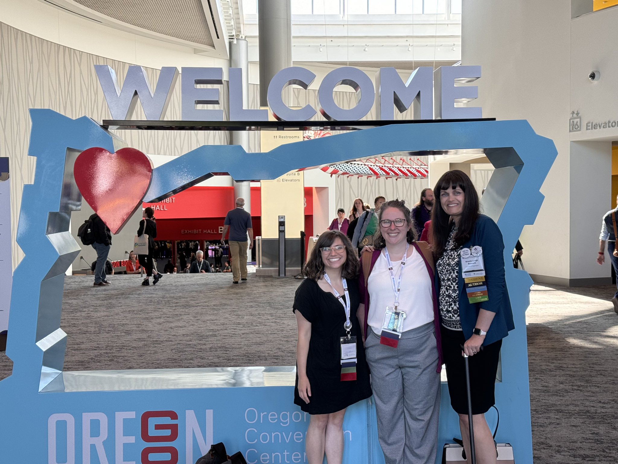 Alex Prybutok, Nicole Minkoff and Kristin Bennett standing in front of the ASEE Annual Conference sign