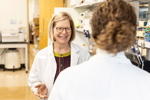 Mary Lidstrom talks to researcher in her lab