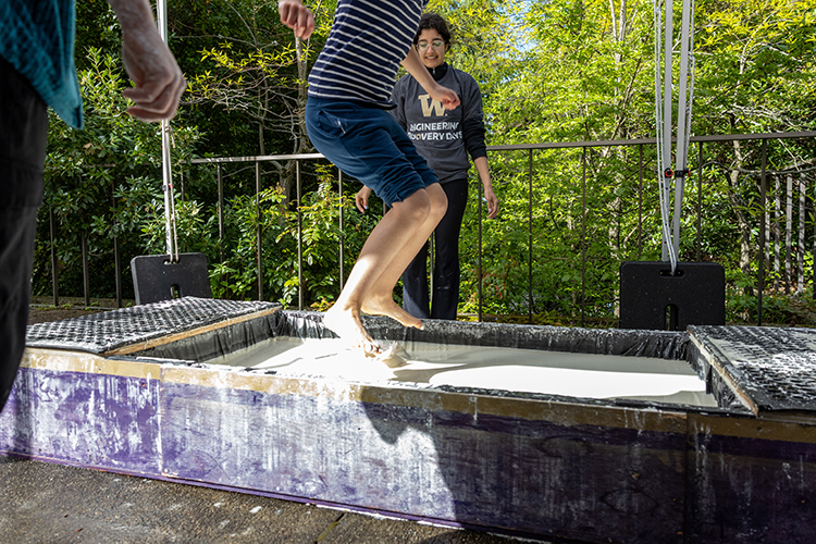 Student jumping in water