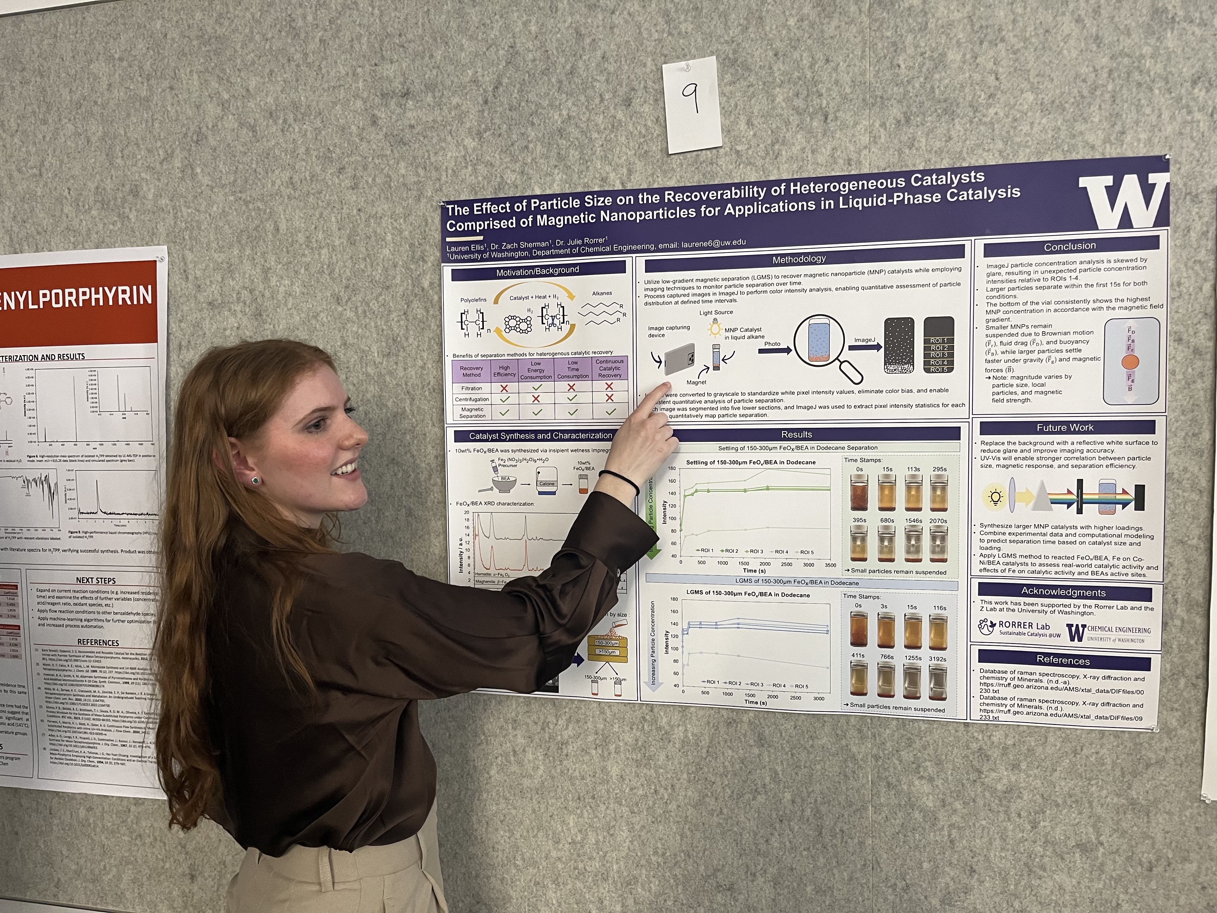 Lauren points to a graphic on her poster while explaining her research.