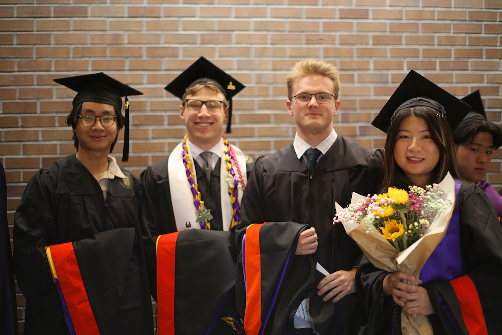 A group of master's students at graduation. 