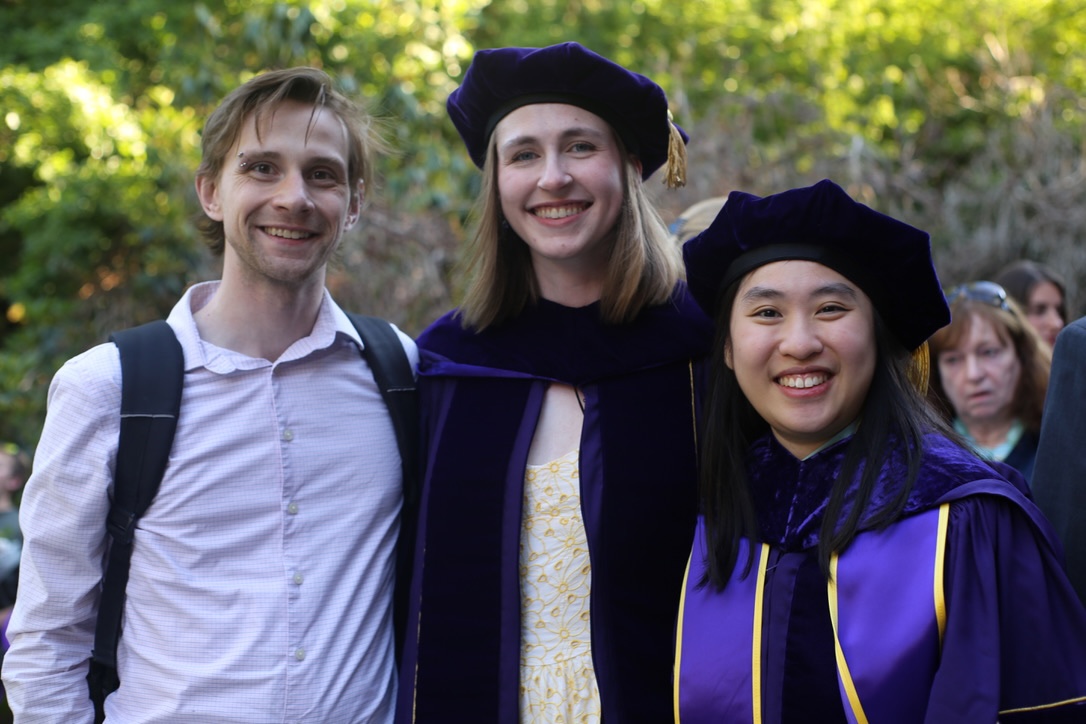 Recent Ph.D. graduates smile at commencement reception. 