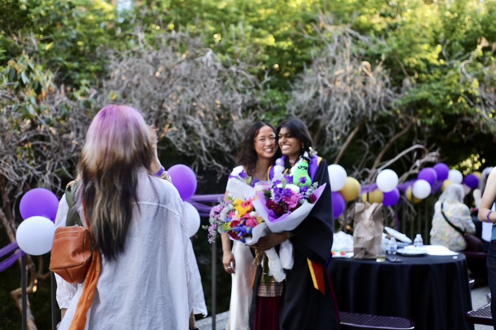 Students take pictures at graduation.