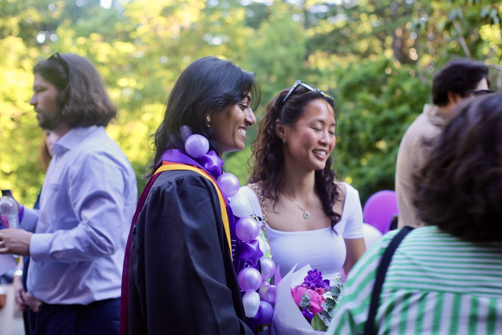 Recent graduates talk at the commencement reception.
