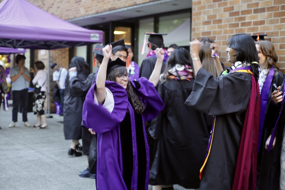 Graduates celebrate with faculty Dr. Alex Prybutok.