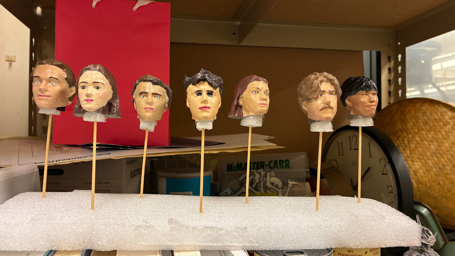 Painted PEZ heads drying on sticks.