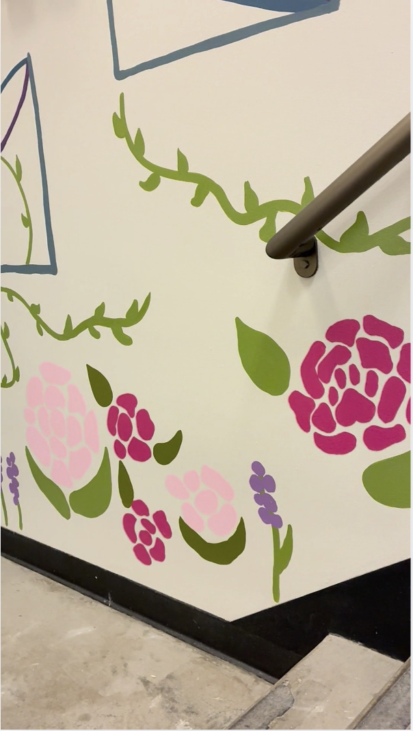 A close-up of the mural with pink and green flowers among ChemE diagrams.