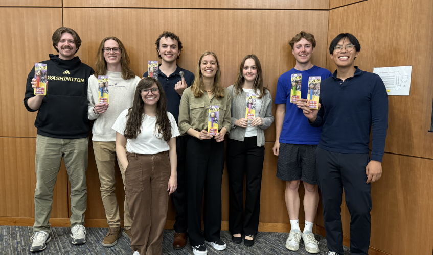 Students hold their PEZ dispensers and stand with Dr. Prybutok. 