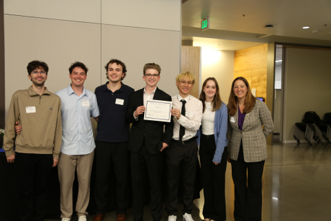 Several students from "Cal-Cu-lator" hold a certificate while standing with Department Chair Elizabeth Nance. 